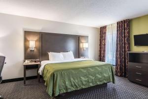 a hotel room with a bed and a television at Quality Inn Warsaw near Rappahannock River in Warsaw