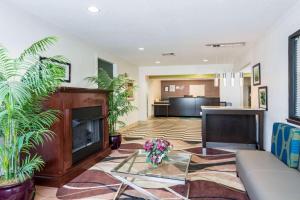 a living room with a fireplace and a couch at Quality Inn Warsaw near Rappahannock River in Warsaw