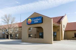 a building with a sign for a comfort inn at Comfort Inn in Colby