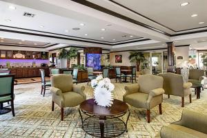 a lobby of a hotel with chairs and a table at Quality Inn & Suites in Robstown