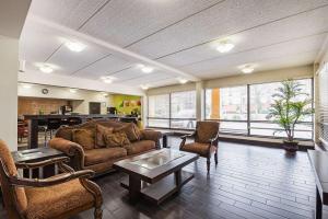 a living room with a couch and chairs and a table at Quality Inn Airport - Southeast in Birmingham