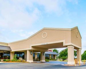 a front view of a building with a parking lot at Clarion Inn & Suites Dothan South in Dothan