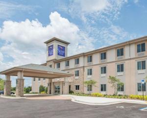 a hotel with a building with a clock tower at Sleep Inn & Suites Defuniak Springs in Mossy Head