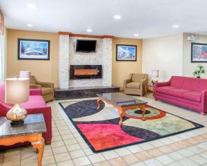 a living room with a couch and a fireplace at Quality Inn Ottawa near Starved Rock State Park in Ottawa