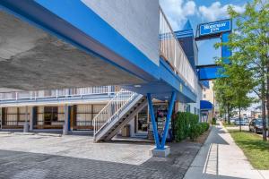 a blue building with a staircase in front of it at Rodeway Inn in Chicago