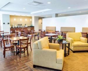a restaurant with chairs and tables and a bar at Sleep Inn & Suites Defuniak Springs in Mossy Head