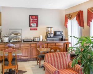 a kitchen with a counter and a table and chairs at Econo Lodge in Brunswick