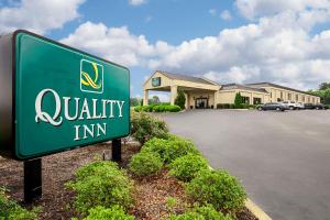 a sign for a quality inn in a parking lot at Quality Inn Holly Springs South in Holly Springs