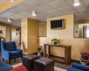 a waiting room with a tv and blue chairs at Quality Inn Hayti North in Hayti