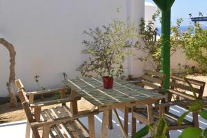 a wooden table with a potted plant on it at Paradisia Villas in Naxos Chora