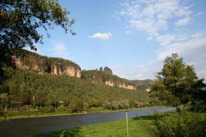 a river with a mountain in the background at Haus Sonate in Bad Schandau