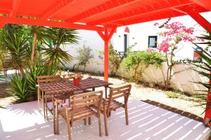 a table and chairs sitting under a pergola at Paradisia Villas in Naxos Chora