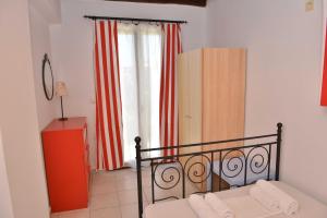 a bedroom with a bed and a window at Paradisia Villas in Naxos Chora