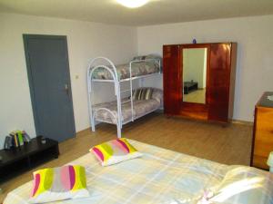 a bedroom with a bunk bed and a mirror at LA CASA DEI NONNI in Acqualagna