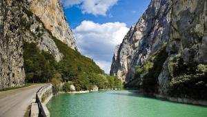 a road next to a river between two mountains at LA CASA DEI NONNI in Acqualagna