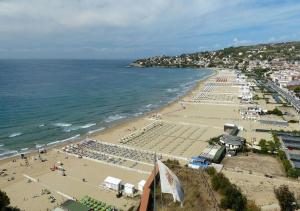 a beach with a crowd of people and the ocean at A Casa di Lidia B&B Gaeta in Gaeta