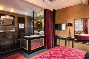 a hotel room with a bed and a bathroom with a shower at The Pavilions Amsterdam, The Toren in Amsterdam