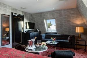 a living room with a couch and a table at The Pavilions Amsterdam, The Toren in Amsterdam