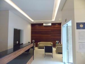 a waiting room with a table and a chair at Hotel Mattes in Joinville