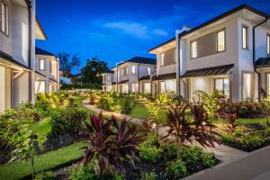a row of houses with plants and trees at Beach View Hotel in Saint James