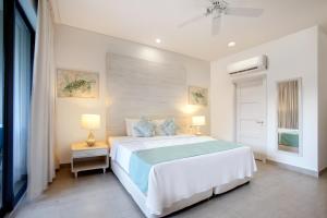 a bedroom with a bed and two lamps and a window at Beach View Hotel in Saint James