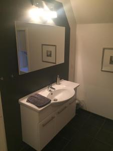 a bathroom with a sink and a mirror at Lykkebjerg in Varde +11 photos