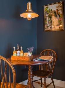 a dining room table with two chairs and a lamp at Cotswold Place in Cirencester
