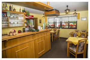 a restaurant with a bar with tables and chairs at U Bernardýna in Harrachov