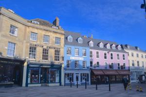 a group of buildings on a city street at Cotswold Place in Cirencester