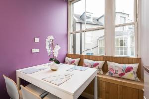 a dining room with a white table and a window at Large City Centre Apartment in Perth