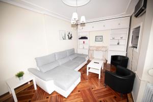 a living room with a couch and a table at Espacios Blanco Santiago - con parking. in Valladolid