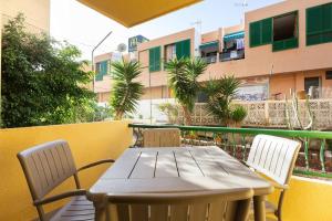 a table and chairs on a balcony with a building at Torres del Sol in Arona