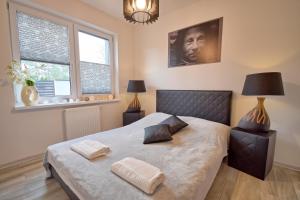 a bedroom with a bed with two pillows on it at Apartament Cinema in Mielno