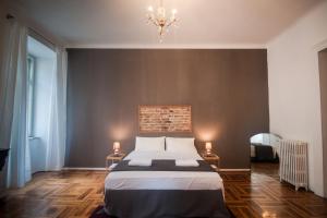 a bedroom with a bed and a chandelier at Agli incanti in Trieste +24 photos