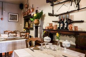 a dining room with a table and a fireplace at hôtel Piellenia in Tardets-Sorholus