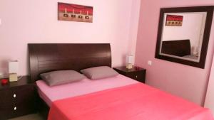 a bedroom with a large bed with a red blanket at Luxury Apt at Navarino Square in Thessaloniki