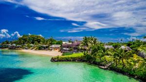 a view of a beach with palm trees and the ocean at Le Lagoto Resort & Spa in Fagamalo
