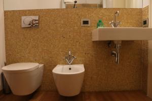 a bathroom with a toilet and a sink at Le BB in Bari +31 photos