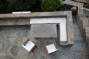 an overhead view of two chairs and a bench at Petra Traditional House in Episkopión