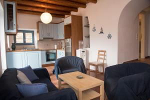 a living room with two couches and a kitchen at Petra Traditional House in Episkopión