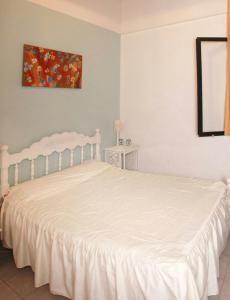 a bedroom with a bed with a white bedspread at Casa Huespedes en Hotel Villa Rosarito in Villa del Totoral