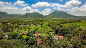 an aerial view of a mountain with a village and trees at Hotel Eco Arenal in Fortuna