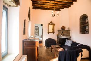 a living room with a couch and a table at Petra Traditional House in Episkopión