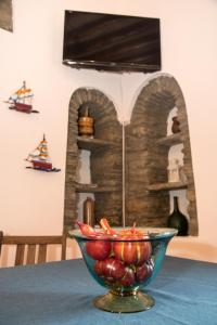 a bowl of fruit sitting on top of a table at Petra Traditional House in Episkopión
