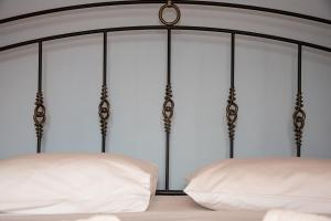 a bedroom with a bed with white sheets at Petra Traditional House in Episkopión