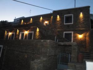 a brick house with lights on the side of it at Petra Traditional House in Episkopión