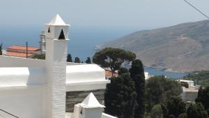 a white church with a view of a mountain at Petra Traditional House in Episkopión
