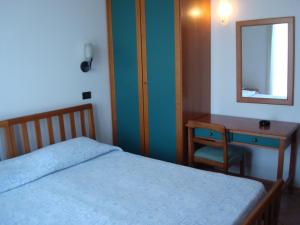 Ένα ή περισσότερα κρεβάτια σε δωμάτιο στο Albergo Cenni