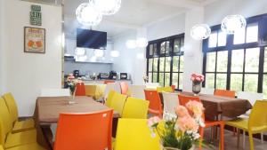 a dining room with tables and colorful chairs at Sn David Apartelle in Kaybagal