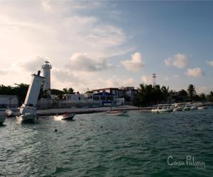 a group of boats in the water near a harbor at Casa Palma Hotel in Playa del Carmen